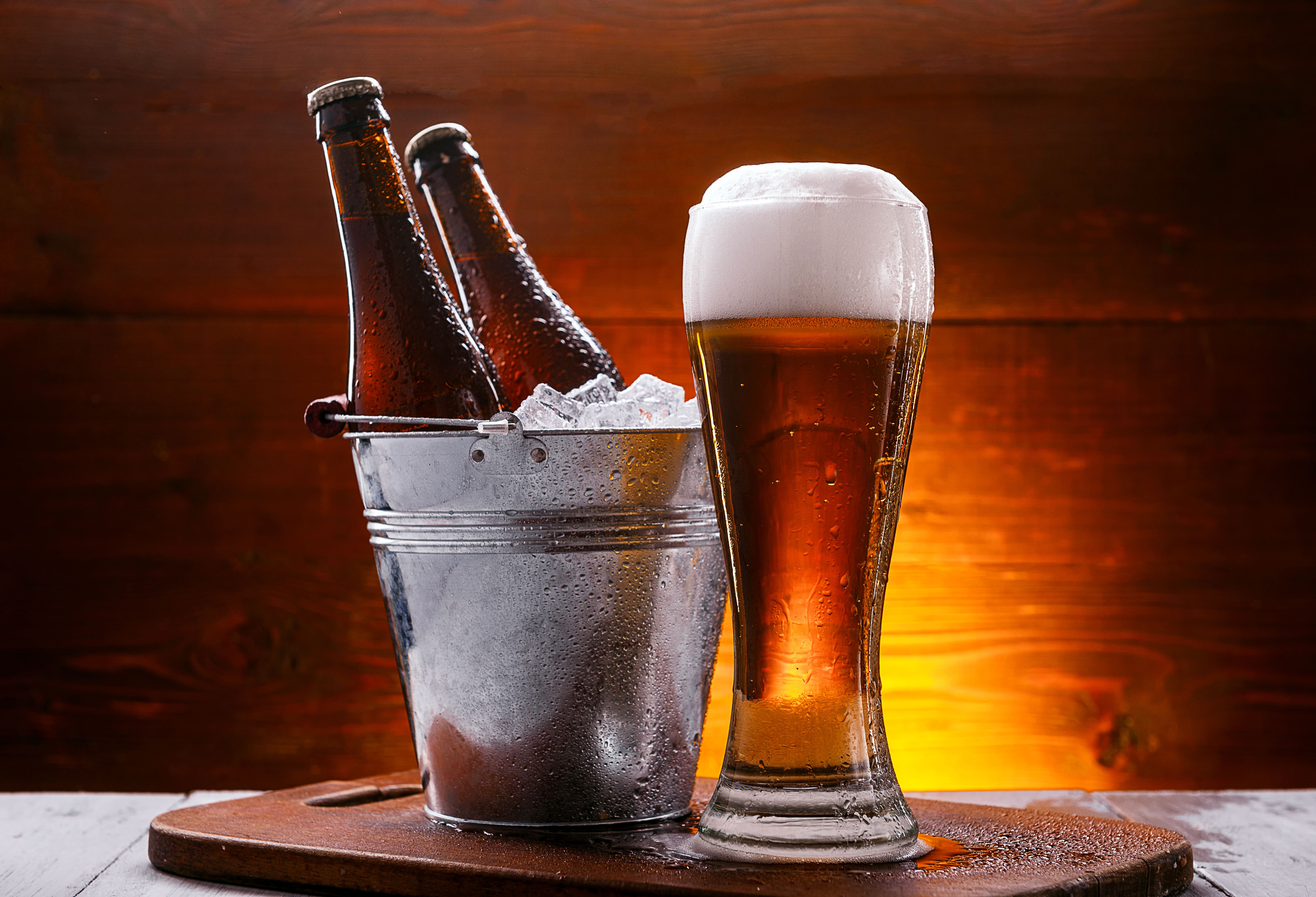 two-bottles-beer-bucket-with-ice-glass-beer-with-lush-foam